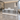 Retail Reception Desk 31-87 in Wide with Stainless Steel, LED Lighting & File Drawers — 45 degree view in a commercial office