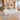 Silver and white wave-front reception counter in the same furnished lobby, 45-degree view