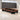 Brown closed elongated ring conference table with black panel supports in the office, full room view