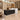 Black and white marble reception counter with raised right privacy panel in a furnished office, 45-degree view