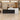 Black and white marble reception counter with raised right privacy panel in a furnished office, front view