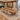 Brown wood boat conference table with trapezoid supports in a furnished boardroom, 45-degree view