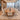 Brown wood boat conference table with trapezoid supports in a furnished boardroom, side view