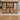 Brown wood boat conference table with trapezoid supports in a furnished boardroom, front view