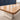 Oak conference table with ivory central cable band, two dark cable covers and ivory cabinet pedestal visible material detail in the same office