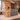 Natural wood and gray stone reception desk with slatted front in a furnished office, 45-degree view