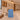 Powder blue and terrazzo reception desk with display niche in a furnished office, side view