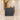 Walnut and charcoal reception counter in a functional hotel lobby, low camera elevation