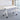 Single white mobile training table without a modesty panel, with curved white frames and four casters in the same office, closer product view